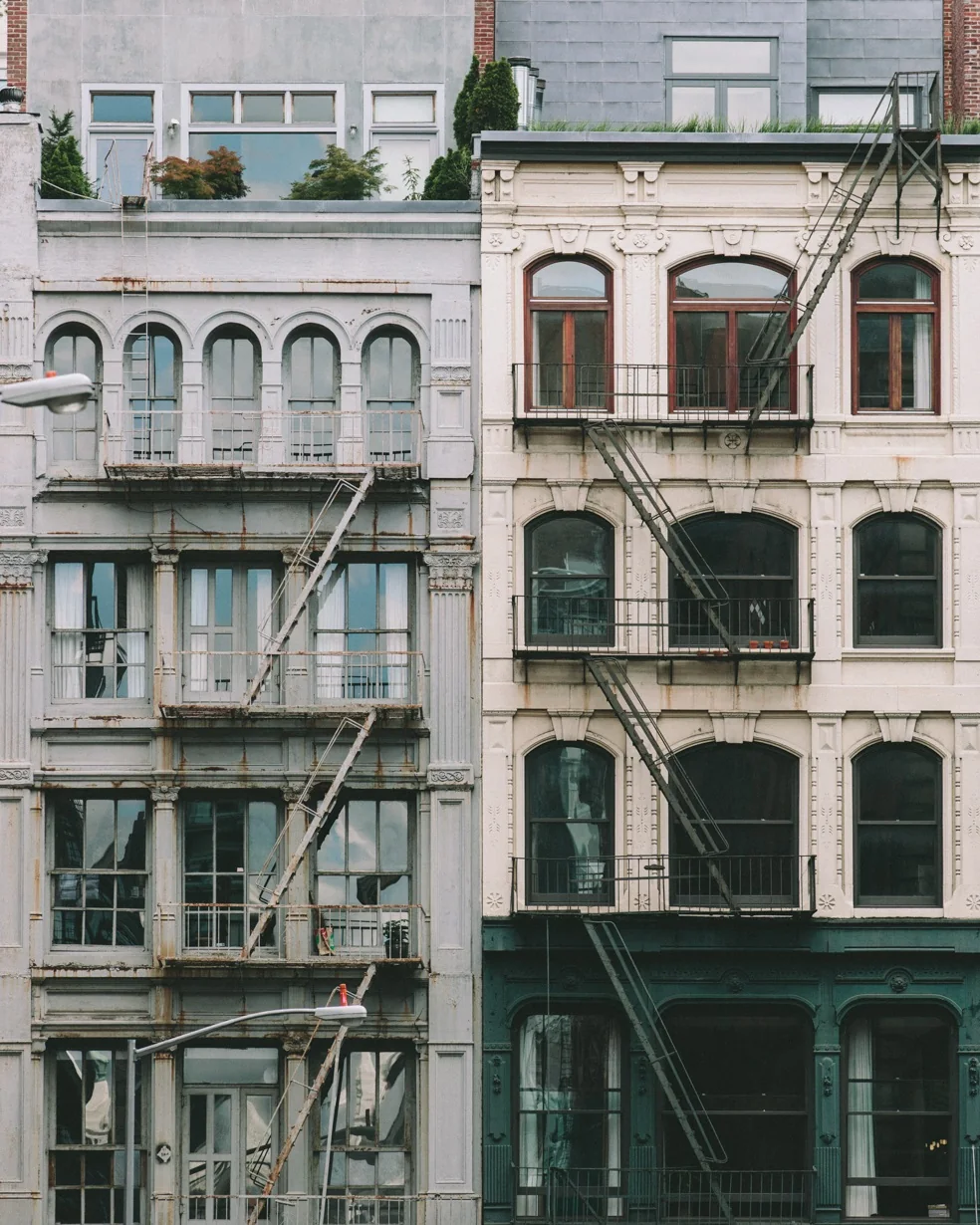 Cast-iron building facades with fire escapes in New York