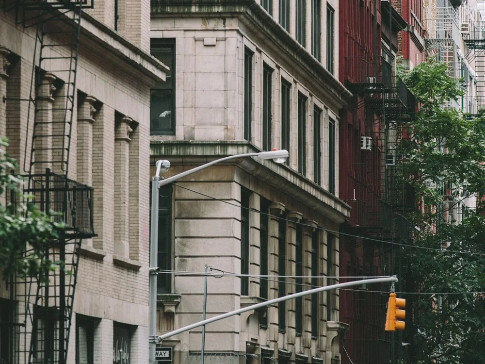 Stone townhouses and a traffic light on a New York street