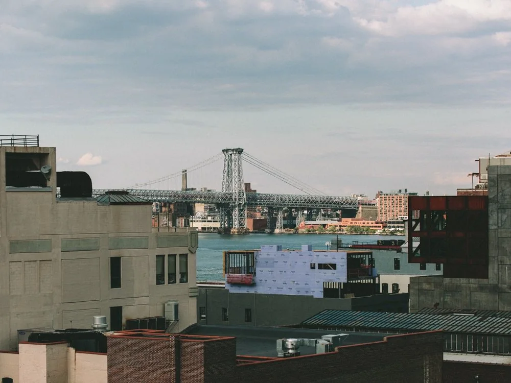 New York rooftops with a bridge in the distance